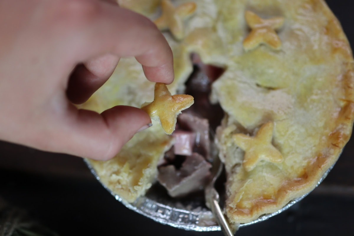 a little hand pulls of a crispy bit of pie crust